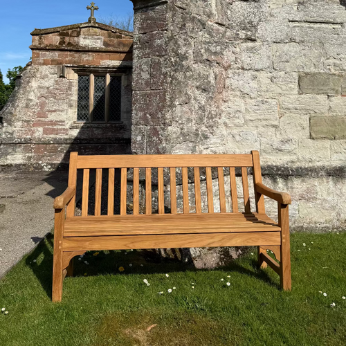 Wooden Teak Chester memorial bench in a church setting in Warwickshire