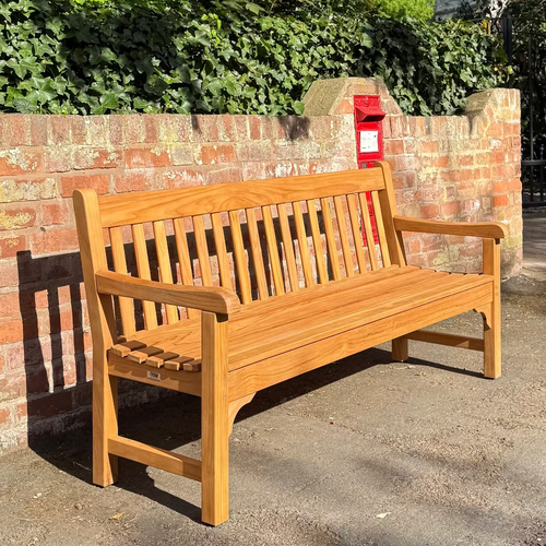 FSC certified teak memorial bench in a park setting