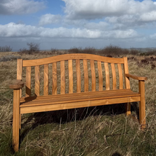 Load image into Gallery viewer, Wooden bench in a field with a blue sky and clouds