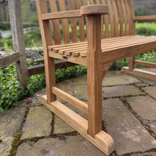 Load image into Gallery viewer, Wooden Oxford bench with a set of feet on a stone patio with a garden background