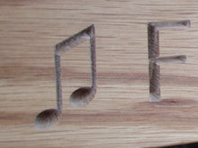 Load image into Gallery viewer, Beam quaver note carved into wood on memorial bench