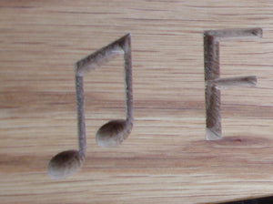 Beam quaver note carved into wood on memorial bench