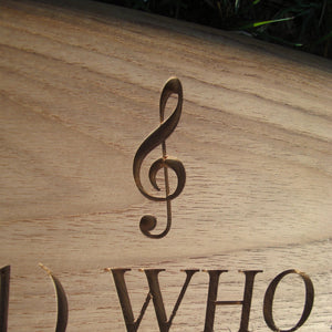 Musical note symbol "Treble Clef" carved into wood on memorial bench - 4mb1550