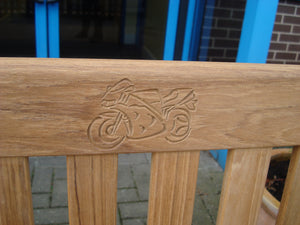 sports motorbike carved into wood on memorial bench - 4mb2071