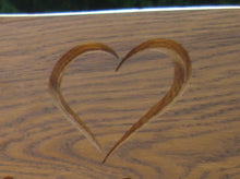 Load image into Gallery viewer, Heart symbol carved into wood on a memorial bench - 4mb2330