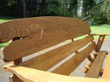 Load image into Gallery viewer, Heart symbol carved into wood on a memorial bench - 4mb2330