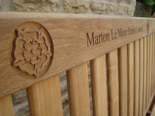 Load image into Gallery viewer, Yorkshire rose carved into wood on a memorial bench - 4mb2511