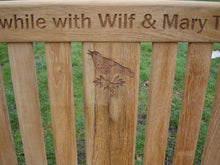 Load image into Gallery viewer, Singing bird on a branch carved into wood on a memorial bench - 4mb1505