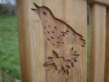 Load image into Gallery viewer, Singing bird on a branch carved into wood on a memorial bench - 4mb1505