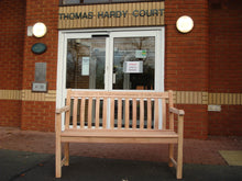 Load image into Gallery viewer, A Teddy bear symbol carved into wood on a memorial bench - 4mb2756