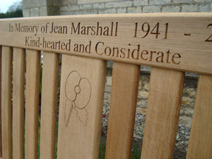 British legion poppy carved into wood on memorial bench - 4mb2890