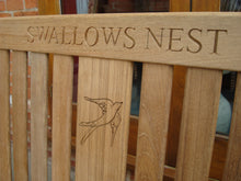 Load image into Gallery viewer, Swallow symbol carving to wood on a memorial bench - 4mb2969