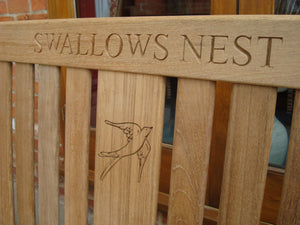 Swallow symbol carving to wood on a memorial bench - 4mb2969