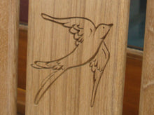 Load image into Gallery viewer, Swallow symbol carving to wood on a memorial bench - 4mb2969