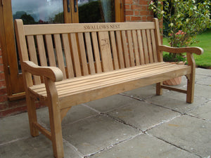 Swallow symbol carving to wood on a memorial bench - 4mb2969