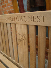 Load image into Gallery viewer, Swallow symbol carving to wood on a memorial bench - 4mb2969