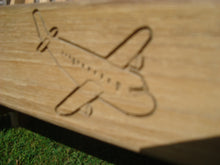 Load image into Gallery viewer, airplane symbol carved into the wood of a memorial bench - 4mb3663