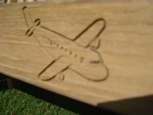 airplane symbol carved into the wood of a memorial bench - 4mb3663