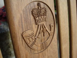 british army rifles regiment insignia carved into wood on a memorial bench