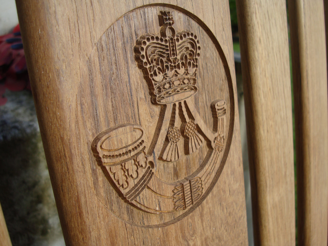 british army rifles regiment insignia carved into wood on a memorial bench