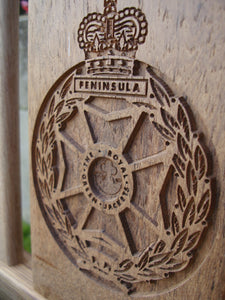 British Army The Royal Green Jackets insignia carved into wood on a memorial bench