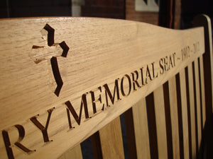 Christian cross symbol carved into wood on memorial bench - 4mb2146