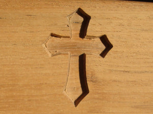 Christian cross symbol carved into wood on memorial bench - 4mb2146