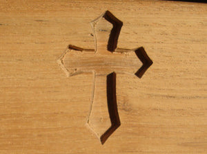 Christian cross symbol carved into wood on memorial bench - 4mb2146