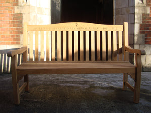 Christian cross symbol carved into wood on memorial bench - 4mb2146
