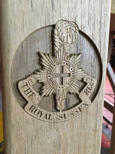 The Royal Sussex Regiment insignia carved on memorial bench