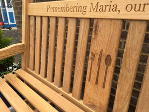 memorial bench with symbol of knife, fork and spoon carved into wood - 4mb4353