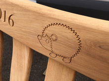 Load image into Gallery viewer, memorial bench with a symbol of a hedgehog carved into wood - 4mb4403
