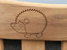 Load image into Gallery viewer, memorial bench with a symbol of a hedgehog carved into wood - 4mb4403
