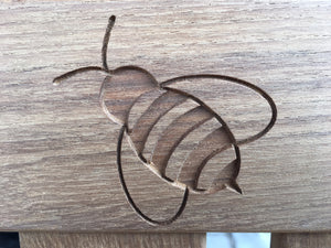 memorial bench with a symbol of a bee carved into the wood - 4mb4457