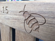 Load image into Gallery viewer, memorial bench with a symbol of a bee carved into the wood - 4mb4457