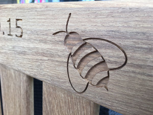 memorial bench with a symbol of a bee carved into the wood - 4mb4457