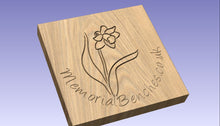 Load image into Gallery viewer, Daffodil carving into wood on a memorial bench