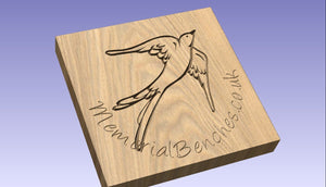 Swallow carved into wood on a memorial bench